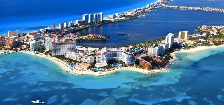 Aerial view of Cancun beachfront hotels and turquoise waters with sandy beaches and surrounding Caribbean coastline